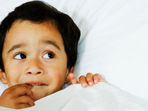 Boy Lying in Bed --- Image by © MM Productions/Corbis